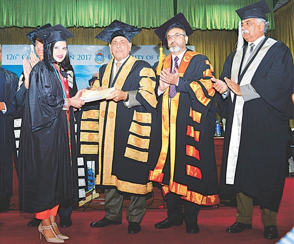 Governor Rafique Rajwana gives away a degree to a student at the Punjab University convocation at Faisal Auditorium. — White Star