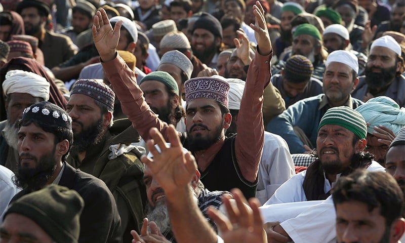 Supporters of Tehreek-i-Labbaik Ya Rasool Allah listen to its leader, Khadim Hussain Rizvi, during a sit-in protest near the capital on Monday.— AP