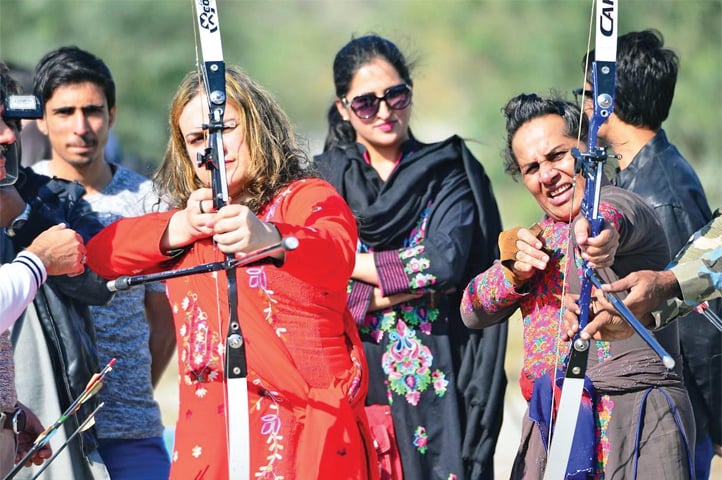 Transgender persons participate in an archery contest during their visit to Attock Khurd on Tuesday. &mdash; Dawn