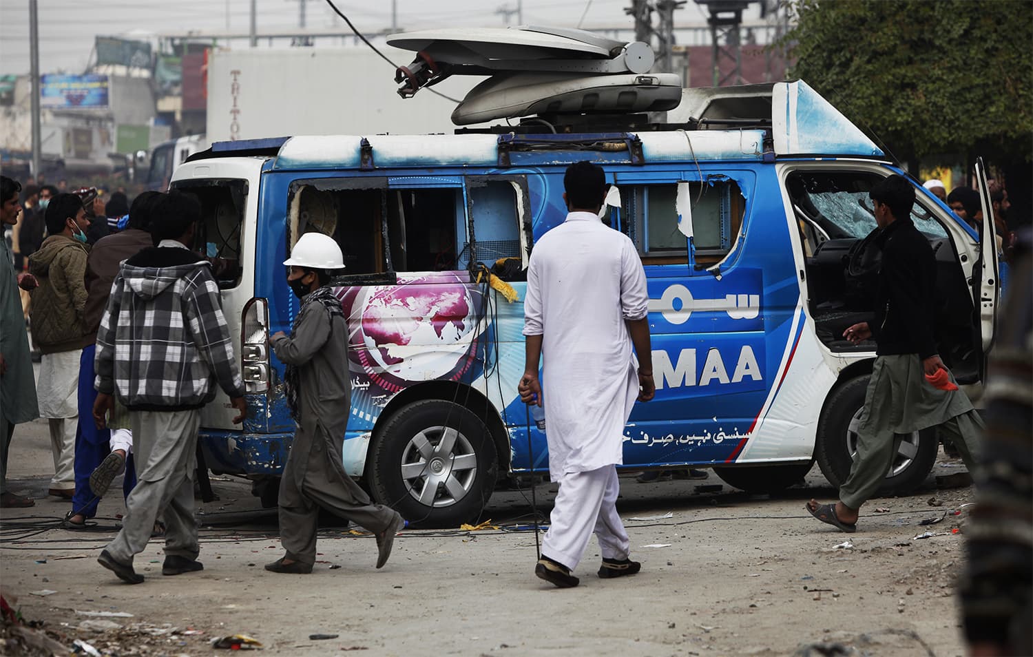 Protesters damage a Samaa DSNG during a clash with police in Islamabad. ─ AP