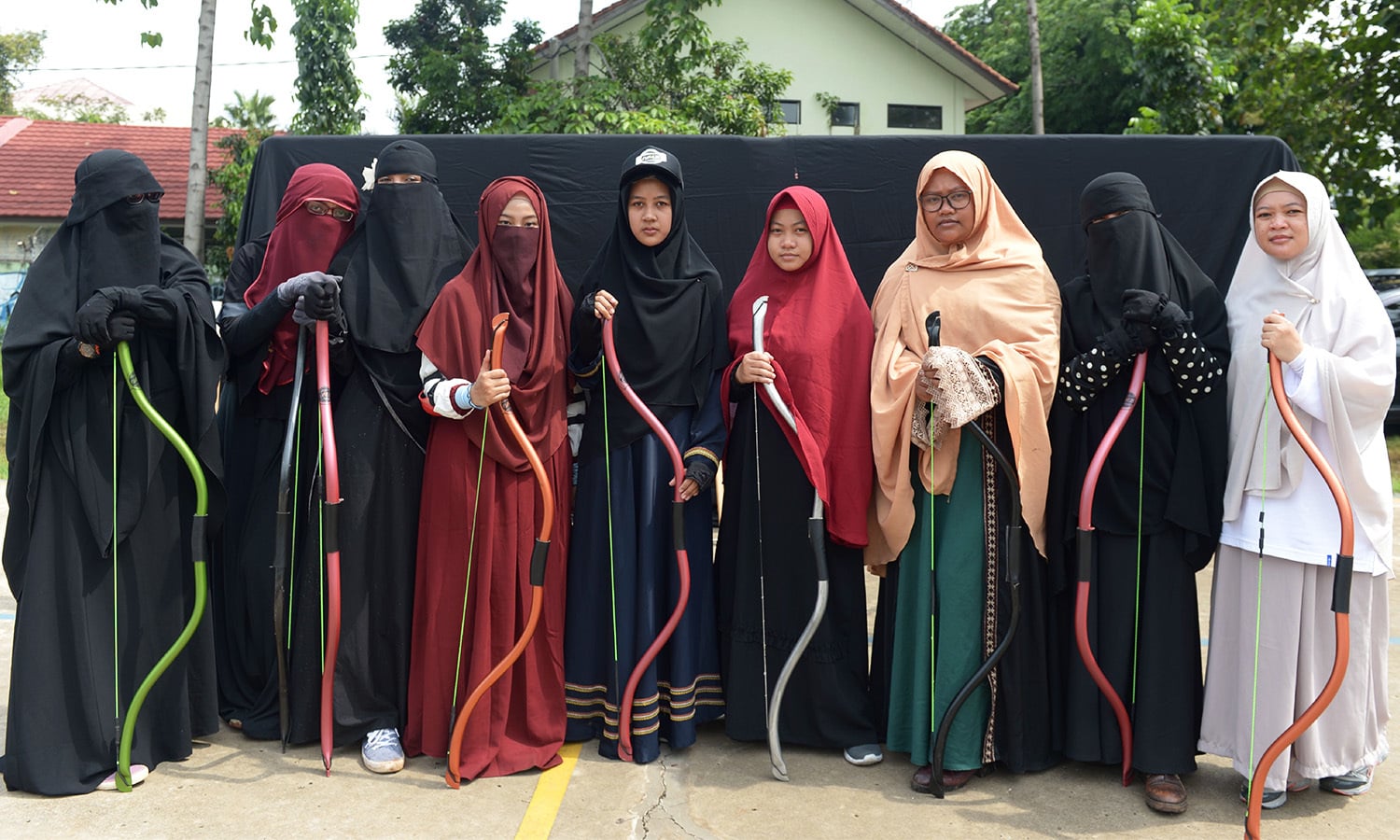 Indonesian Muslim women pose for a photograph after participating in archery and horse riding lessons in Bekasi.— AFP