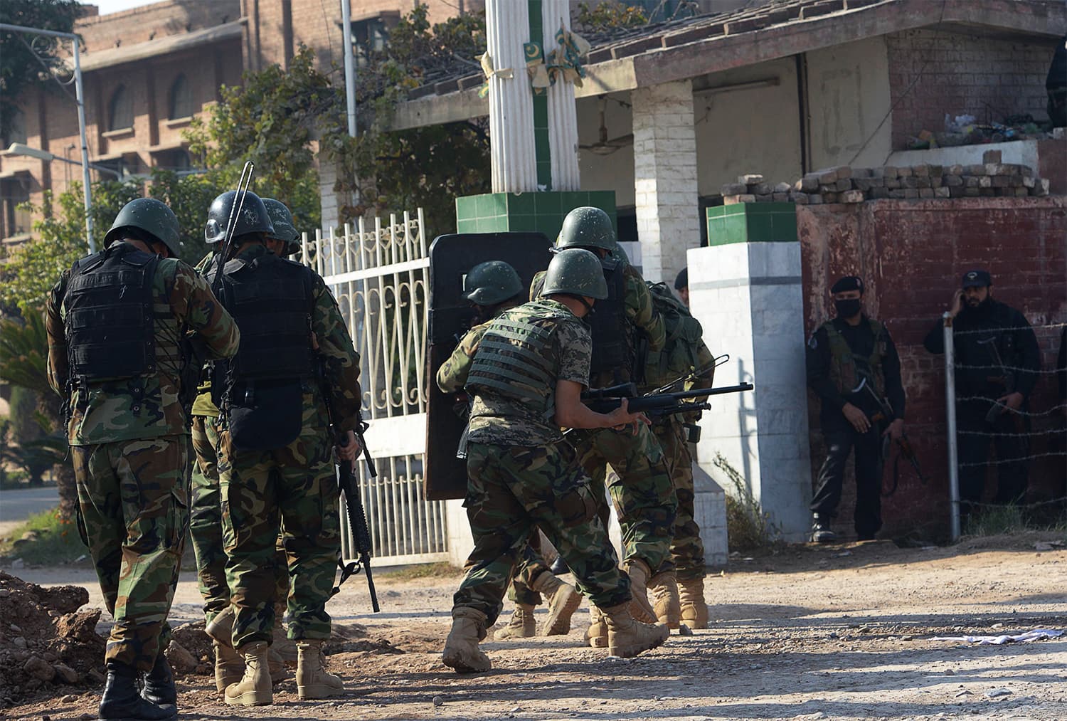 Army troops enter the ATI after the attack. ─ AFP