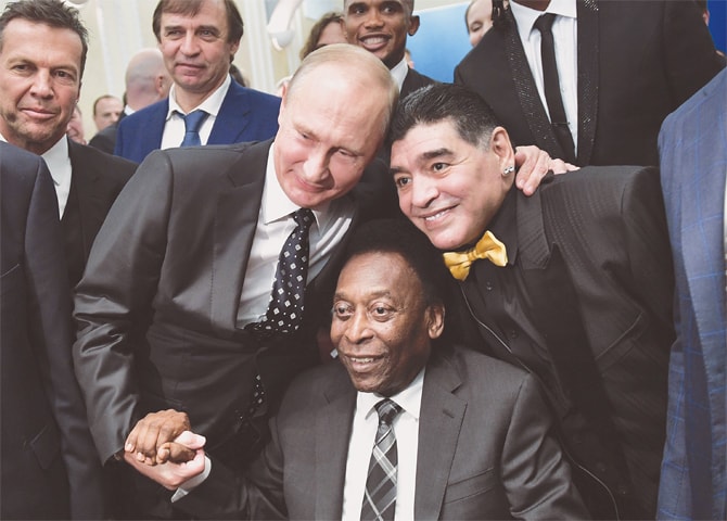 Russian President Vladimir Putin (L), Brazilian legend Pele (C) and Argentina’s icon Diego Maradona pose for pictures ahead of the final draw for the World Cup.—AFP
