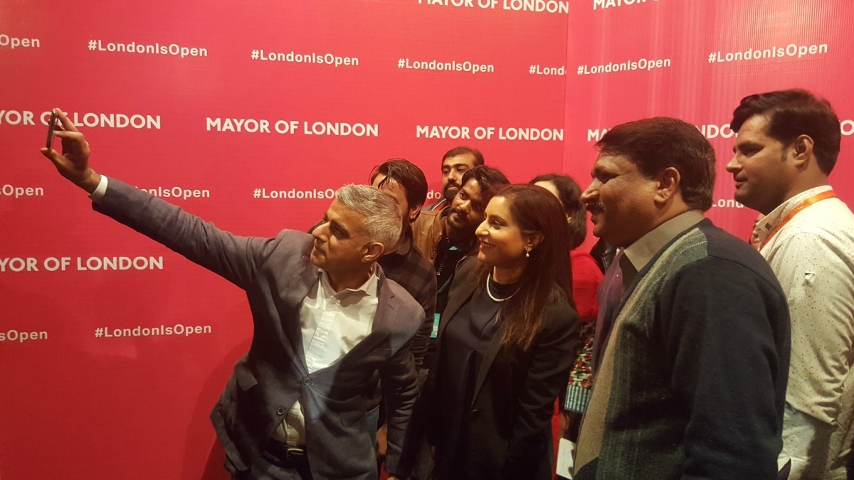 Sadiq Khan takes a selfie with admirers at his talk at Lahore's Alhamra yesterday — Photo by author