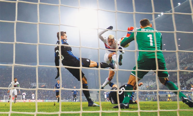 REGGIO EMILIA: Atalanta goalkeeper Etrit Berisha saves from Olympique Lyonnais&rsquo; Mariano during their Europa League match at the Stadio Citta del Tricolore.&mdash;Reuters
