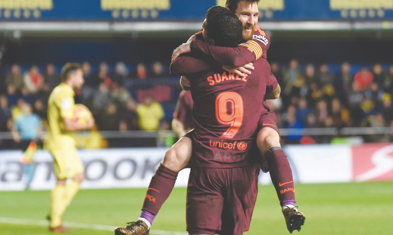 VILA-REAL: Barcelona&rsquo;s Lionel Messi (R) celebrates with team-mate Luis Suarez after scoring during the La Liga match against Villarreal at La Ceramica Stadium.&mdash;AFP