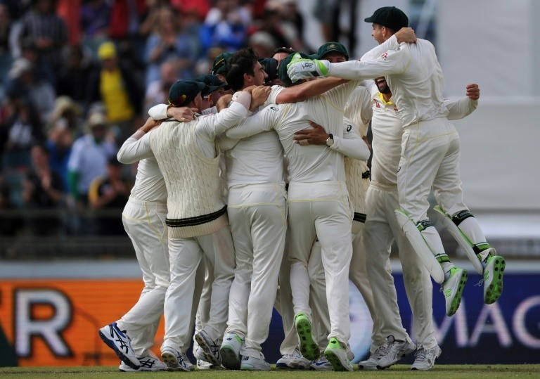 Australian players celebrate taking the Ashes series after bowling England out cheaply despite rain delays and a pitch controversy on the final day of the third Test.&mdash;AFP