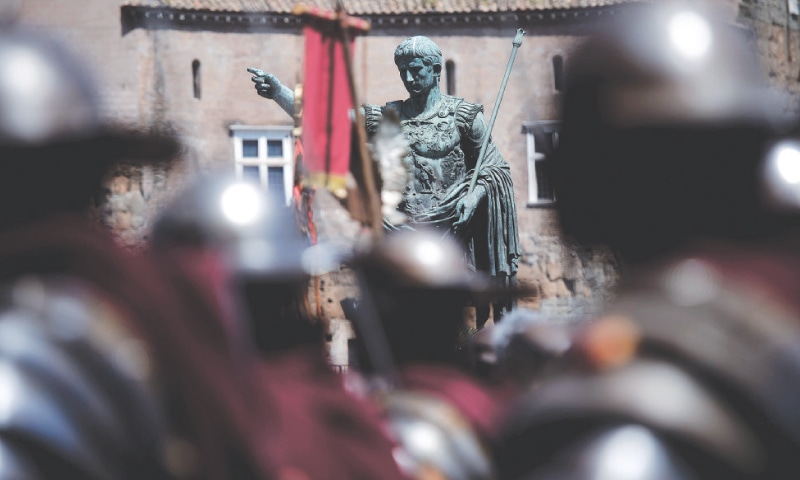 MEN dressed as centurions walk by the statue of Roman Emperor Augustus to mark the anniversary of the legendary foundation of the eternal city of Rome in 753 BC in this file picture taken on April 21, 2014.&mdash;AFP