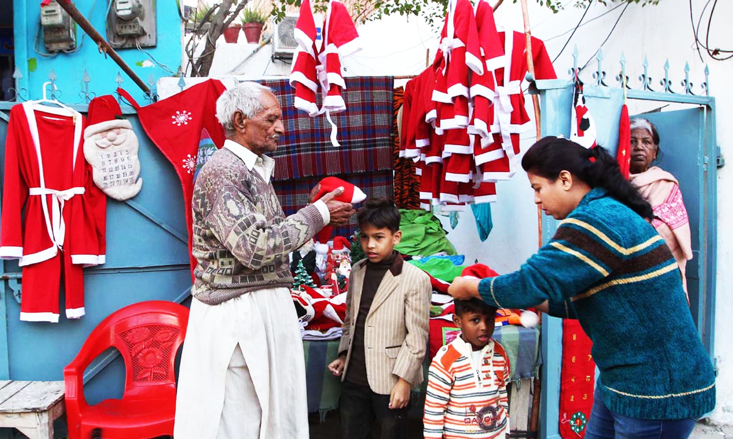 A vendor selling Santa Claus costumes to the customers at his stall. — APP