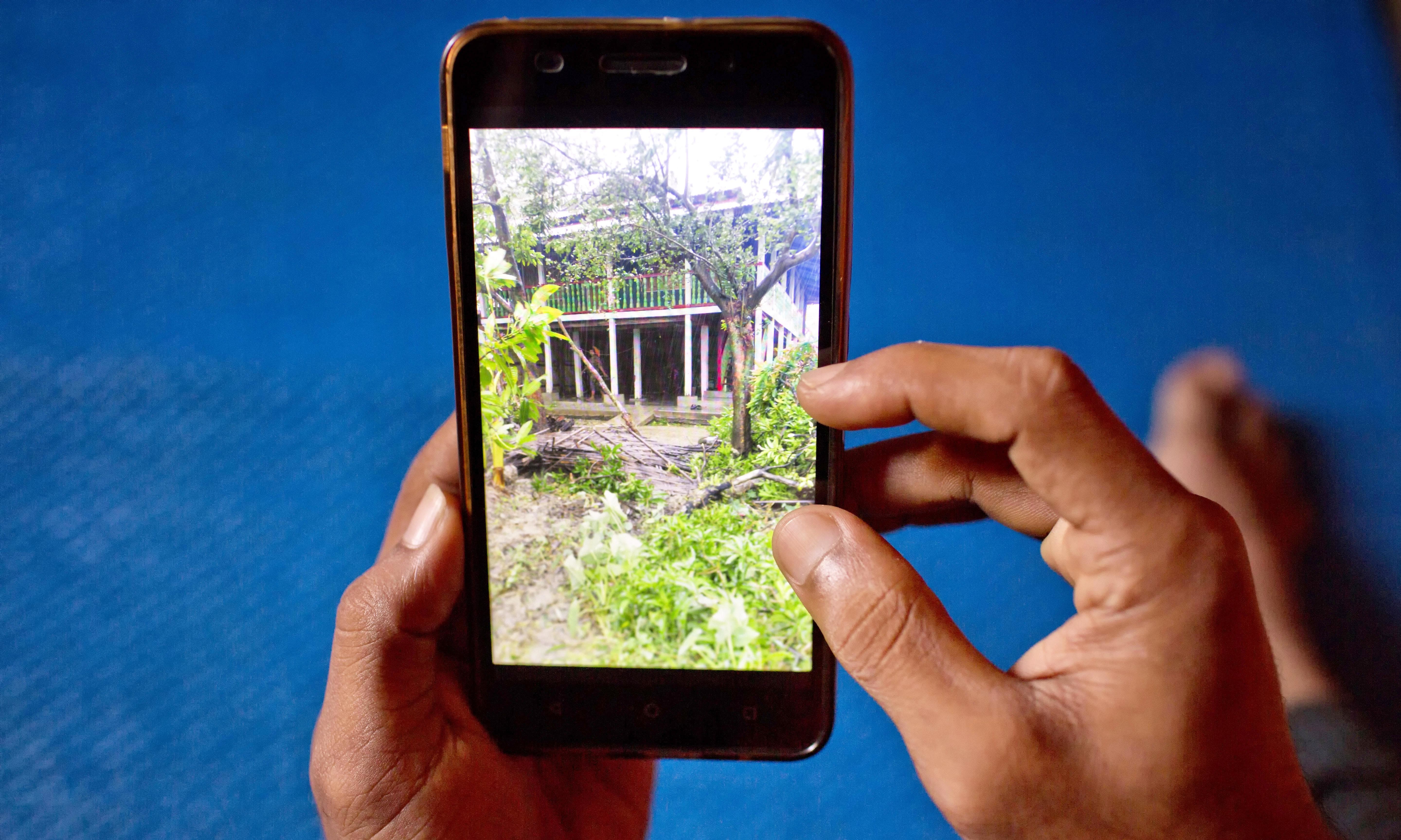 A Rohingya refugee watches a video, which he has shot in Myanmar before crossing over into Bangladesh. —AP