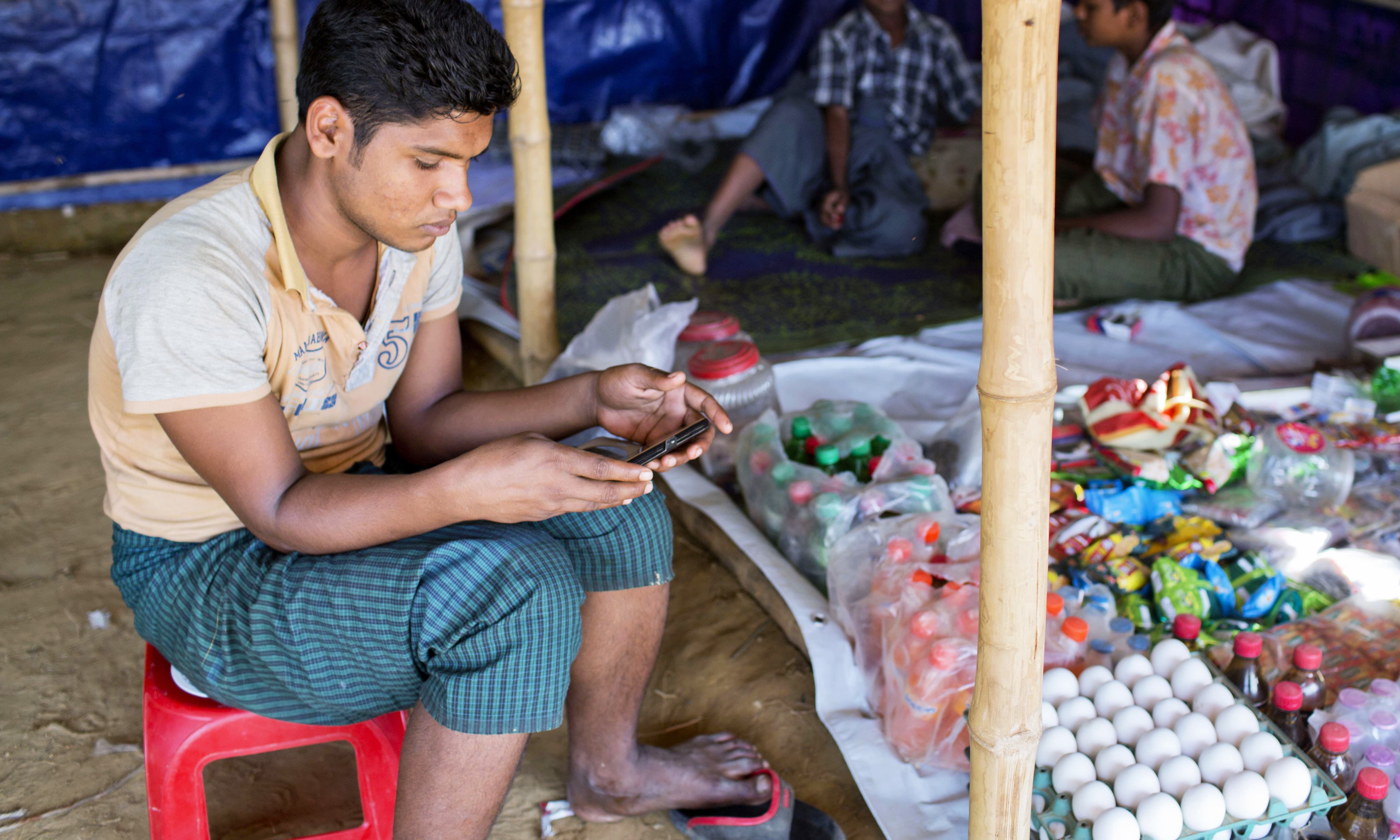 A Rohingya refugee watches a video, which he has shot in Myanmar before crossing over into Bangladesh, at Kutupalong refugee camp in Ukhiya, Bangladesh. —AP