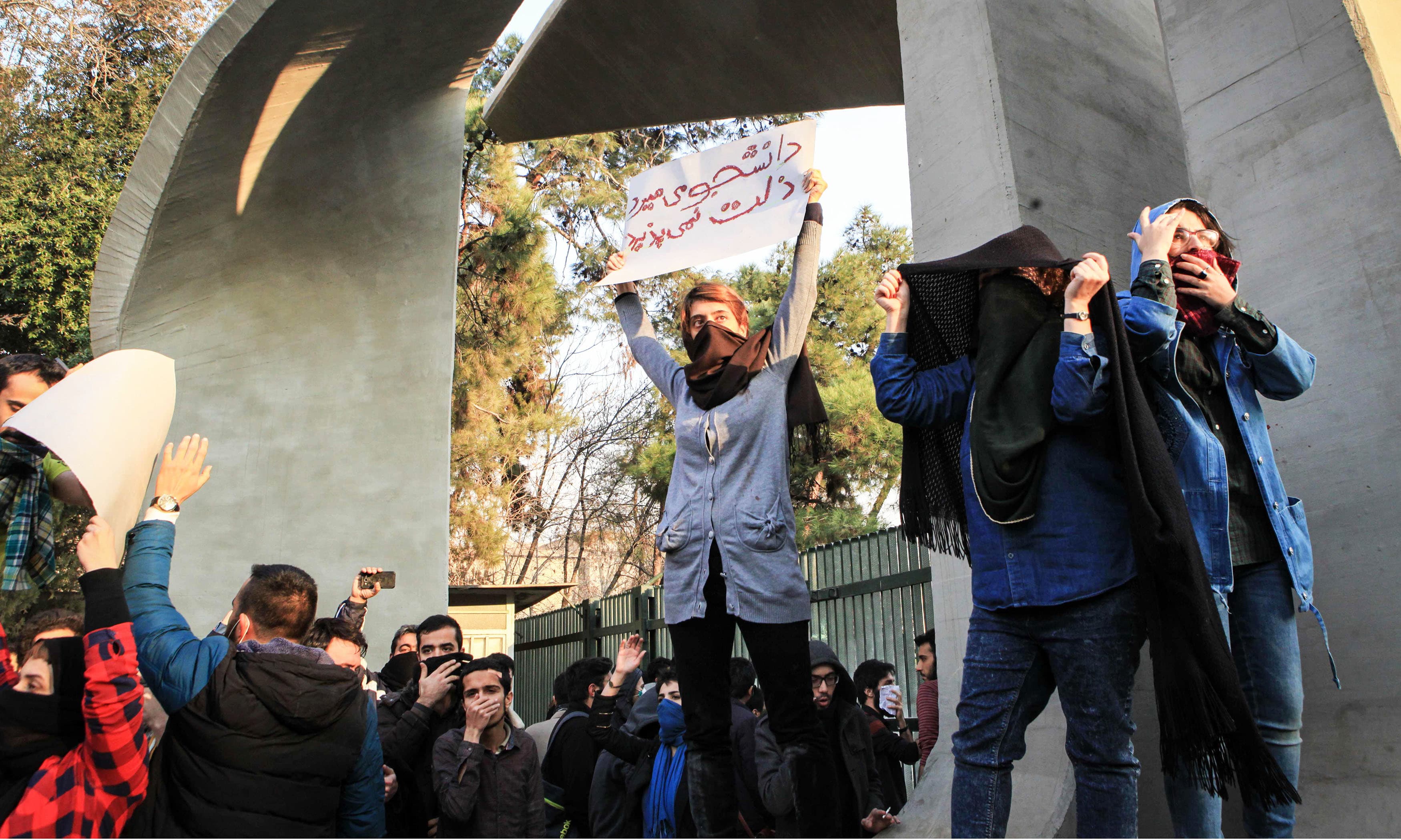 Students protest at the University of Tehran during a demonstration driven by anger over economic problems. —AFP