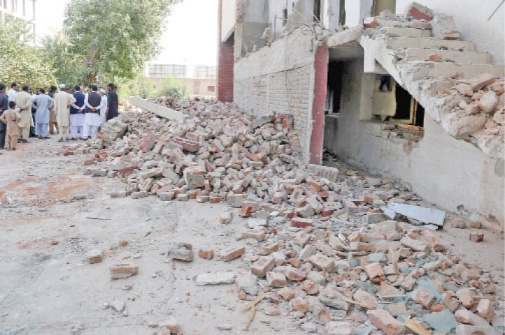 Rubble of a library and a wedding hall on the premises of historical Gor Khatri site after being demolished. &mdash; File photos