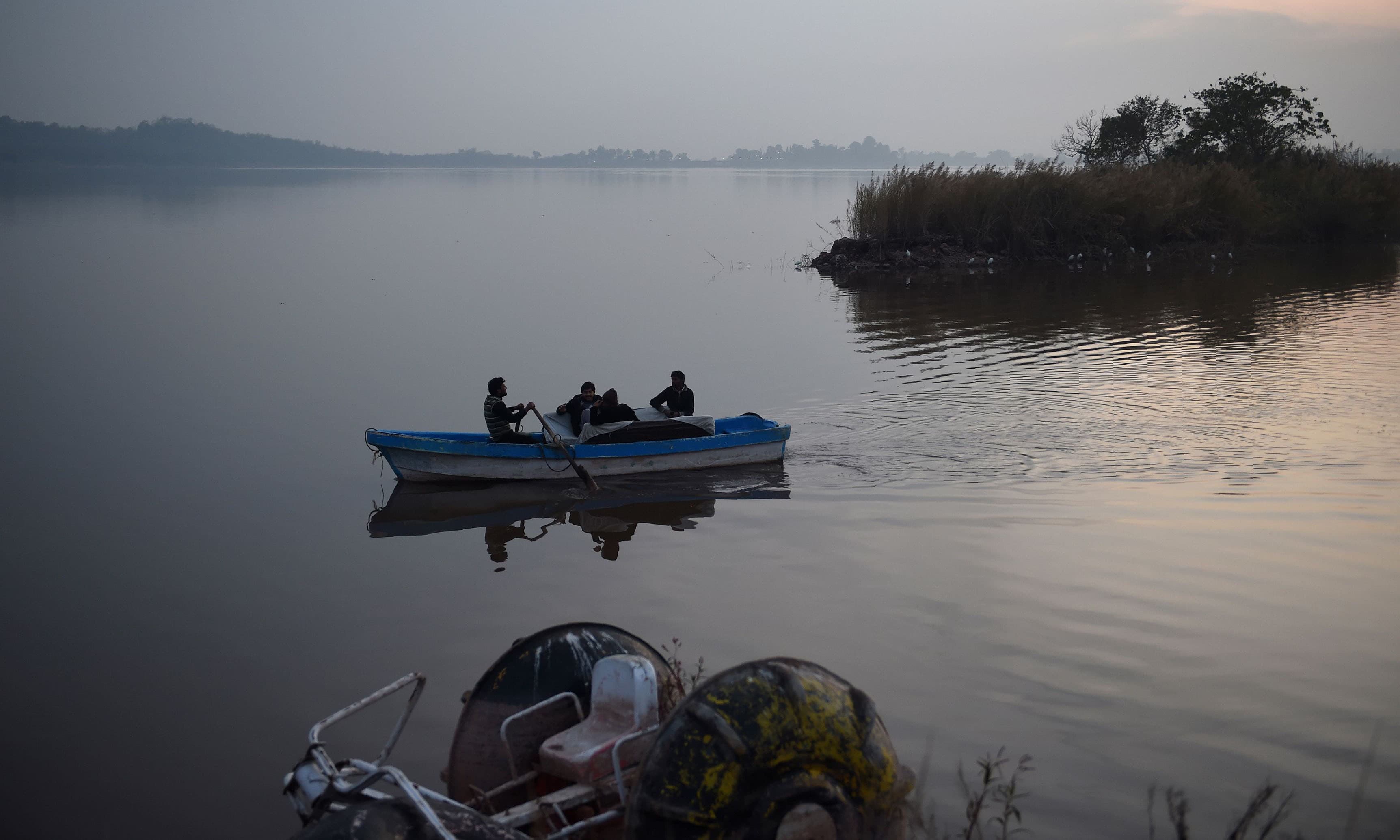 People boating in the Rawal Lake, a water storage basin, in Islamabad.— AFP