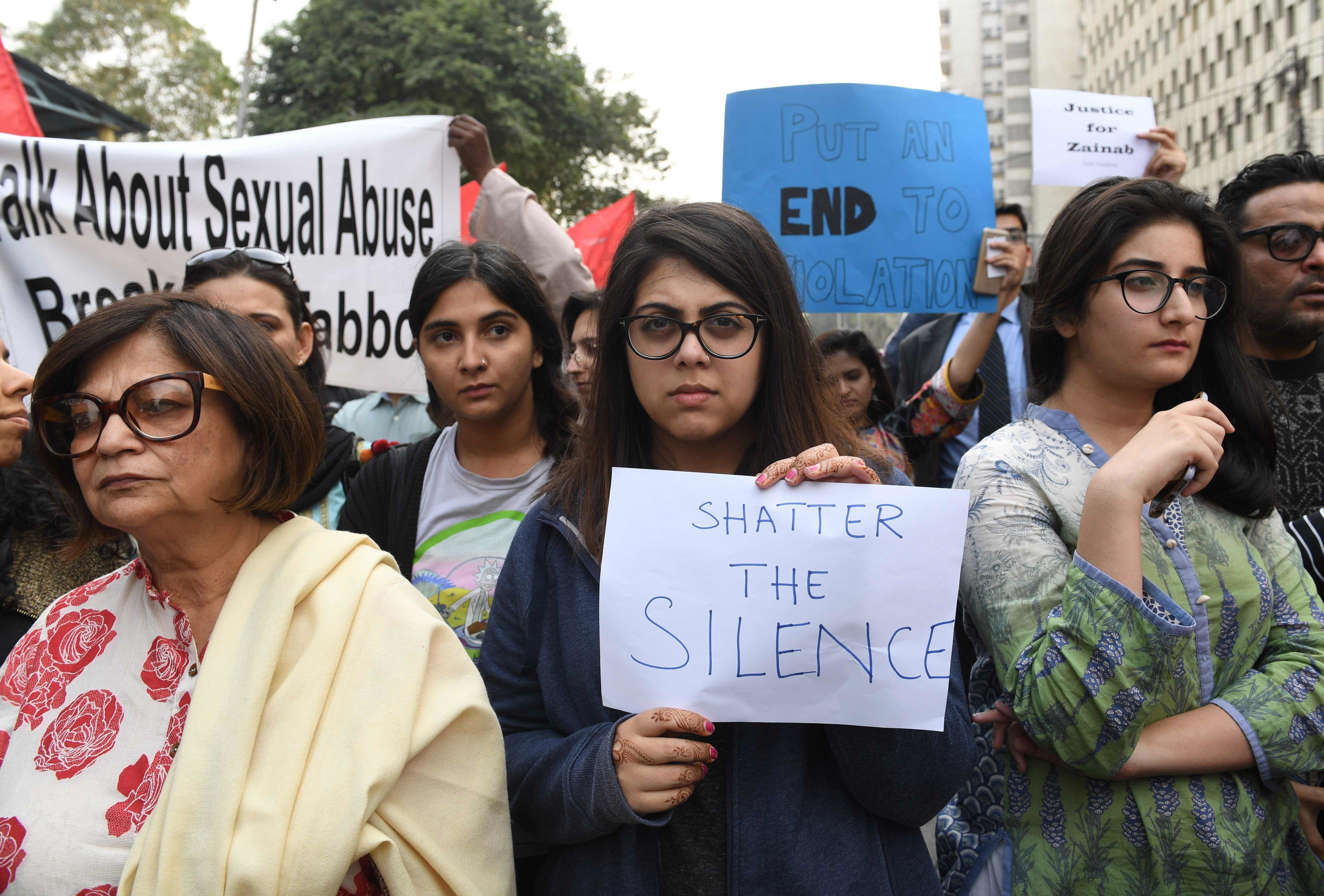 Human rights activists carry placards and banners during a protest against Zainab's rape and murder in Karachi on Thursday.— AFP