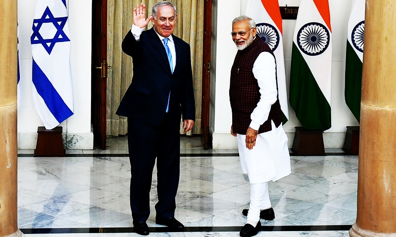 Indian Prime Minister Narendra Modi looks on as Israeli Prime Minister Benjamin Netanyahu waves ahead of a meeting.—AFP