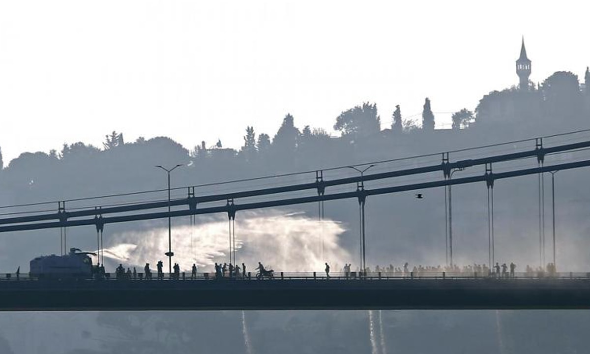 An armoured police vehicle uses a water canon to disperse anti-government demonstrators on the Bosphorous Bridge, Istanbul, in 2016  | Reuters