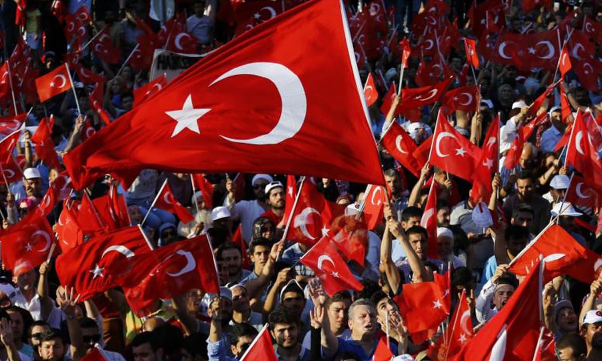 Supporters wave Turkey's national flag while waiting for President Erdog˘an to appear for a speech in Istanbul  | Reuters