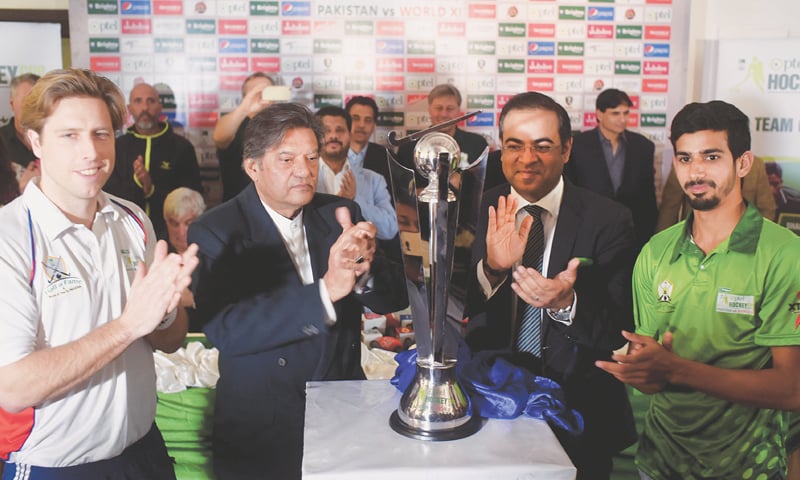 WORLD XI captain Roderick Weustho (L), his Pakistan under-18 counterpart Junaid Manzoor, PHF chief retired Brig Khalid Sajjad Khokhar and PTCL CCO Adnan Shahid unveil the PTCL Cup on Thursday.—White Star