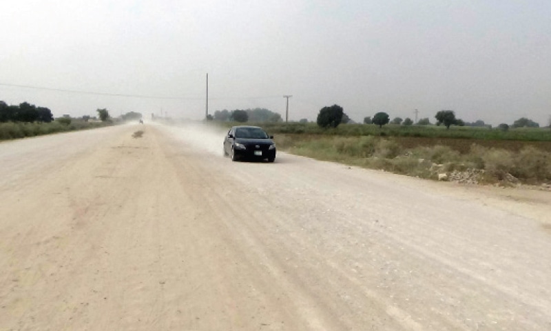 The dusty Chakwal-Sohawa Road. &mdash; Dawn