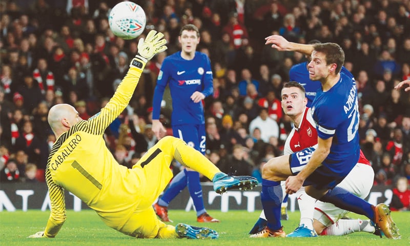 LONDON: Arsenal&rsquo;s Granit Xhaka (C) scores as Chelsea goalkeeper Willy Caballero and Cesar Azpilicueta look on during their English League Cup semi-final second leg at the Emirates Stadium.&mdash;Reuters