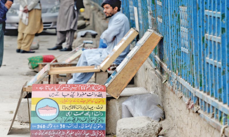 A quack waits for his customers at his roadside setup in Raja Bazaar. &mdash; White Star
