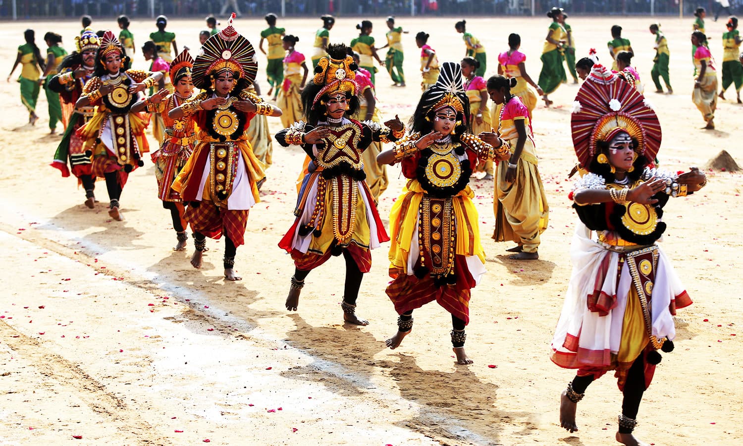 Indian school children dressed in traditional costumes perform during Republic Day celebrations in Bangalore.—AP