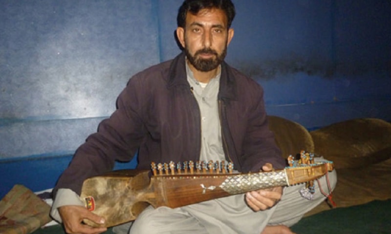 A Pashto folk artist plays rabab in Peshawar’s Kabari Bazaar music street. — Dawn