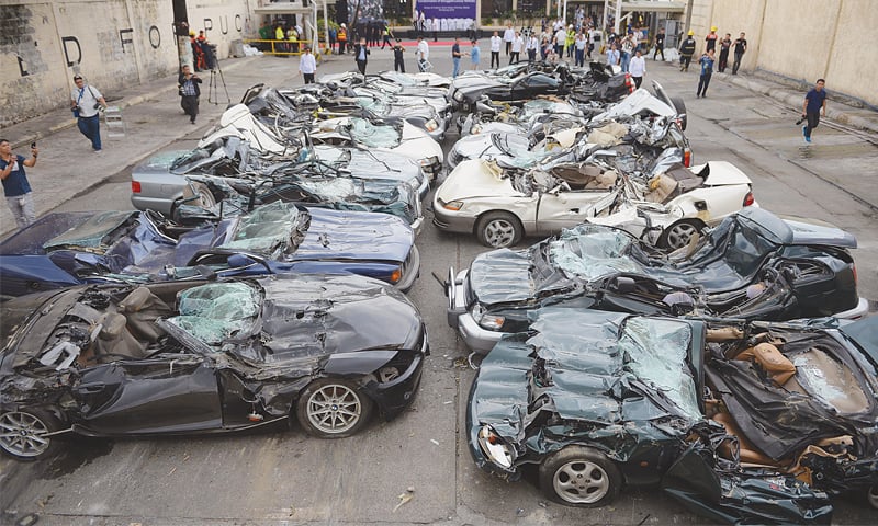 Manila: An overview of crushed luxury vehicles at a customs yard.&mdash;AFP