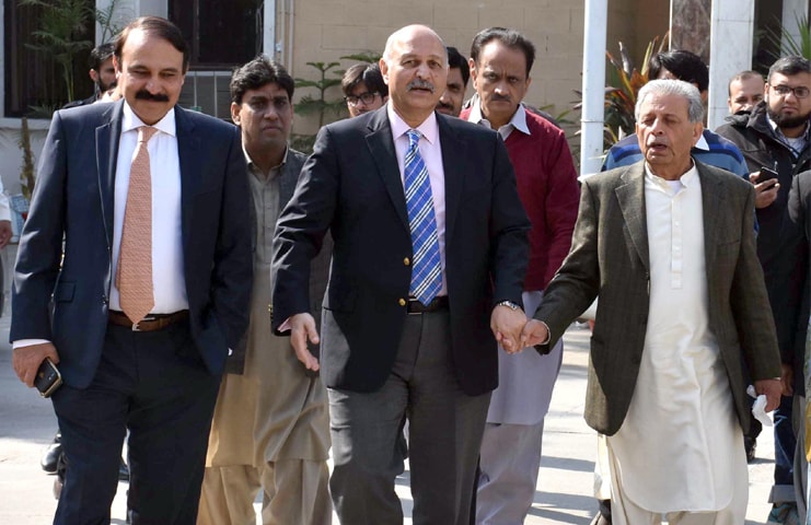 ISLAMABAD: PML-N candidate for a Senate seat Mushahid Hussain Sayed along with other party leaders comes out of the ECP building after submitting his nomination papers on Thursday.—Online