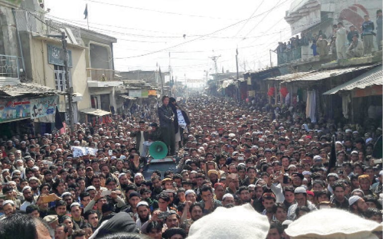 People hold a demo in Inayat Kalley Bazaar of Khar to record their protest against the murder of a student, Ahmed Shah, in Karachi. &mdash; Dawn photo