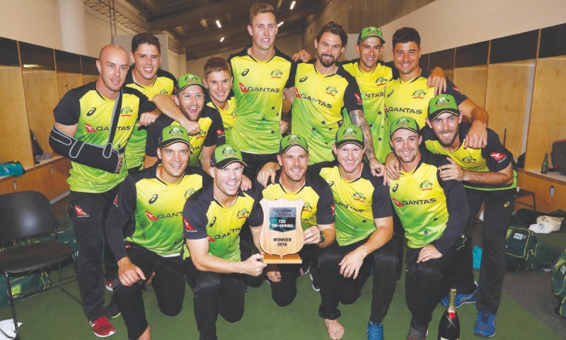 AUCKLAND: Members of Australian cricket team pose with the trophy after winning the tri-series T20 final against 
New Zealand at Eden Park on Wednesday.&mdash;AFP