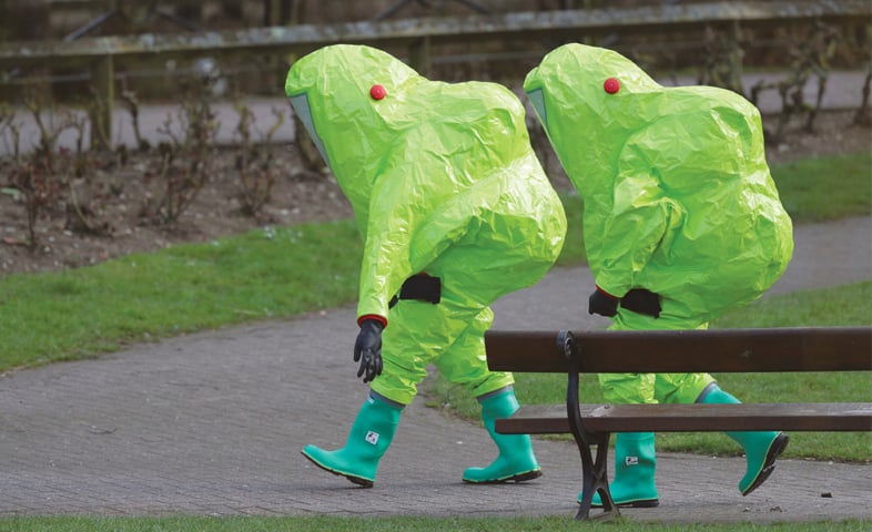 Salisbury (UK): Personnel in hazmat suits walk away after securing the covering on a bench in the shopping centre where former Russian double agent Sergei Skripal and his daughter Yulia were found critically ill on Sunday after exposure to a nerve agent.—AP