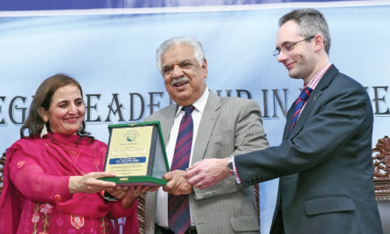 KP Governor Iqbal Zafar Jhagra and Women University Swabi Vice-Chancellor Dr Khanzadi Fatima Khattak giving a shield to Dr Paul Hedlay of University of Oxford, UK, on Friday. &mdash;Dawn