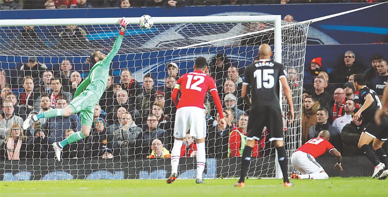 MANCHESTER: Sevilla’s Wissam Ben Yedder (R) heads to score past Manchester United goalkeeper David de Gea during their UEFA Champions League round-of-16 second leg at Old Trafford.—Reuters MANCHESTER: Sevilla’s Wissam Ben Yedder (R) heads to score past Manchester United goalkeeper David de Gea during their UEFA Champions League round-of-16 second leg at Old Trafford.—Reuters