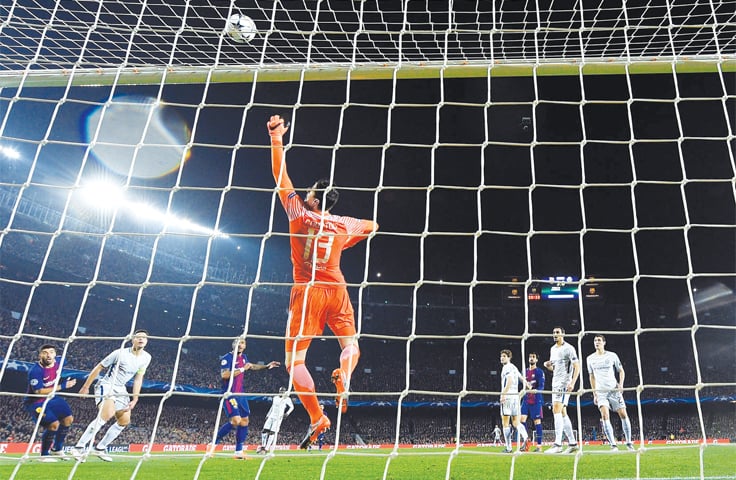 BARCELONA: Chelsea goalkeeper Thibaut Courtois punches the ball away during their UEFA Champions League round-of-16 second leg against Barcelona at the Camp Nou Stadium.—AFP BARCELONA: Chelsea goalkeeper Thibaut Courtois punches the ball away during their UEFA Champions League round-of-16 second leg against Barcelona at the Camp Nou Stadium.—AFP