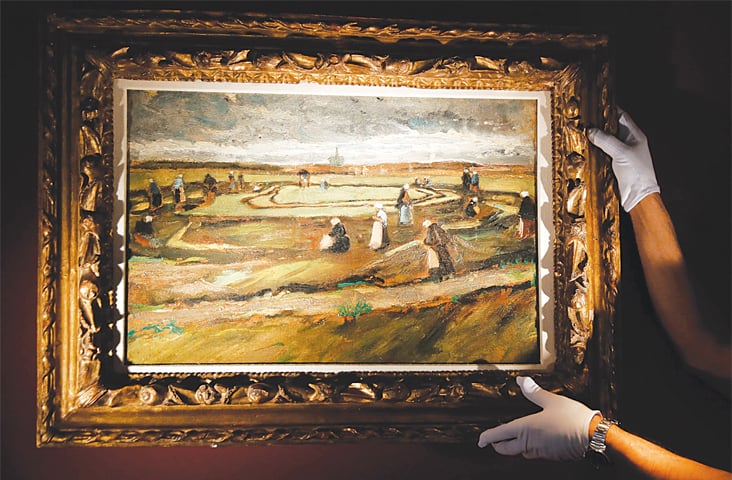 PARIS: Van Gogh’s painting ‘Women mending nets in the dunes’ is being presented for auction.—AFP