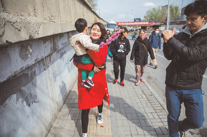 BEIJING: Li Wenzu, wife of a detained rights lawyer, walks away from a court complaints office on Wednesday.&mdash;Reuters