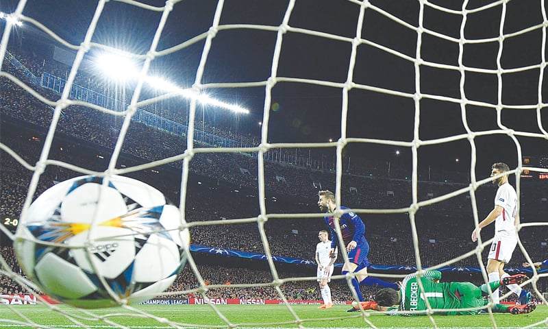 BARCELONA: Barcelona&rsquo;s Gerard Pique (second L) celebrates scoring against AS Roma at the Camp Nou Stadium.&mdash;AFP
