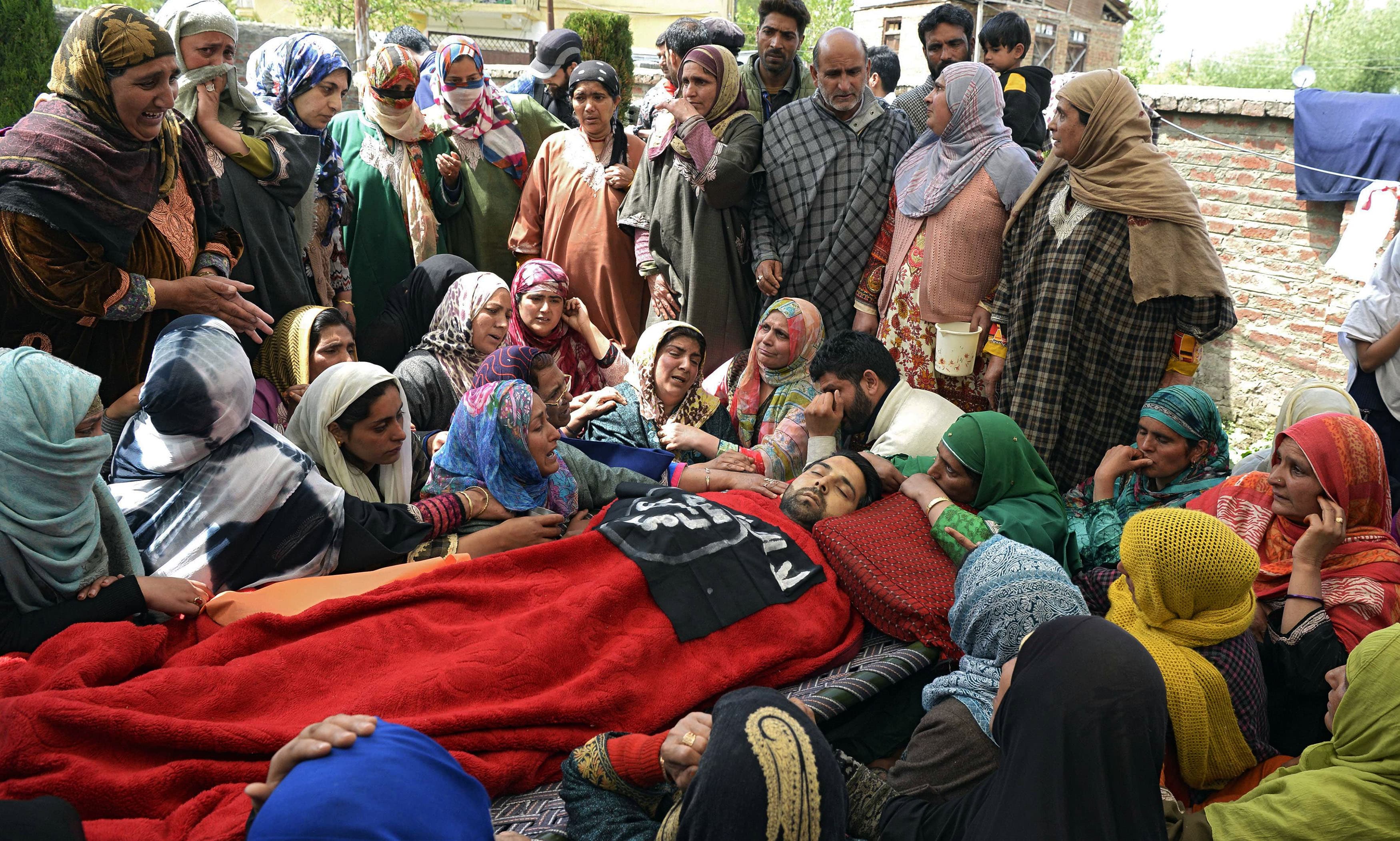 Villagers mourn near the body of slain Kashmiri youth Sharjeel Ahmed. —AFP