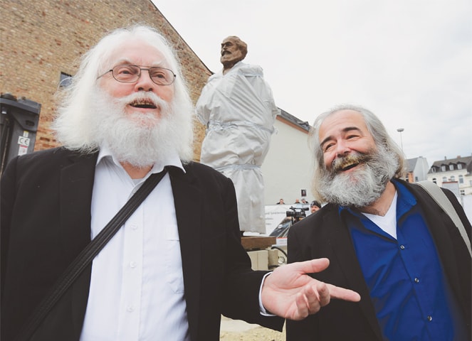 Trier (Germany): German actor Michael Thielen (left) and Henning Laufer attend the installation of a statue of Karl Marx on Friday before its official inauguration on May 5.&mdash;AFP