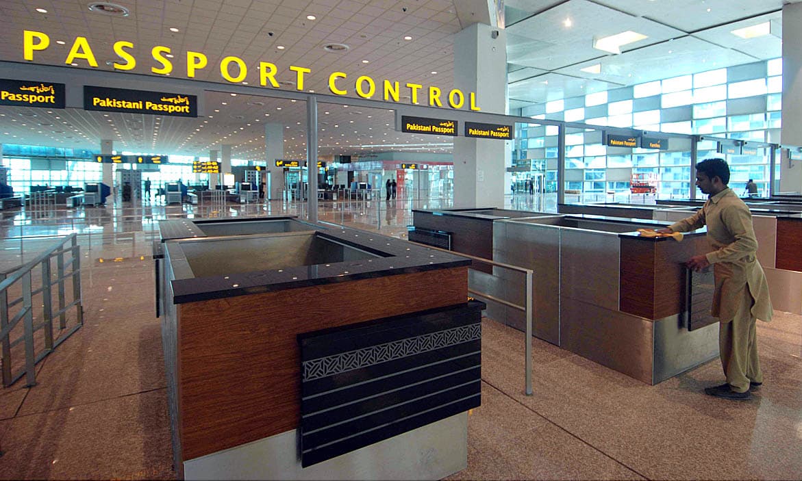 Labourers giving final touches to inner area of newly constructed international airport. — APP