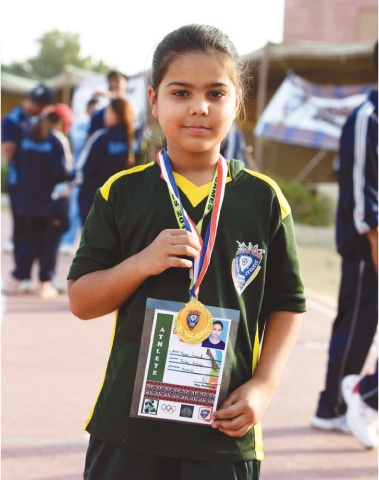 NINE-YEAR-OLD Hoor Fawad, the youngest gold medal winner of the Sindh Games in table tennis women’s team event poses on Sunday.—White Star