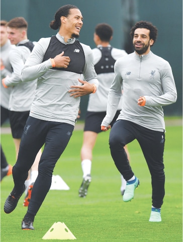 LIVERPOOL’S Virgil van Dijk (L) and Mohamed Salah attend a training session at the team’s Melwood training complex on Monday.—AFP