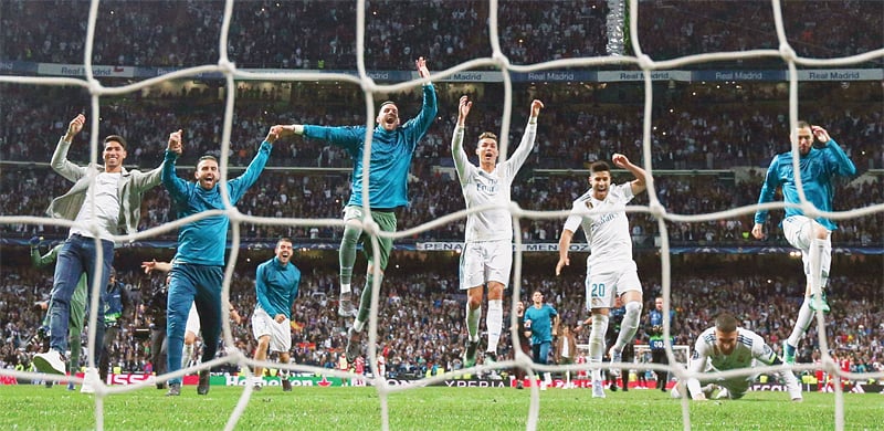 MADRID: Real Madrid players celebrate winning against Bayern Munich in their UEFA Champions League semi-final second leg at the Santiago Bernabeu Stadium.&mdash;Reuters