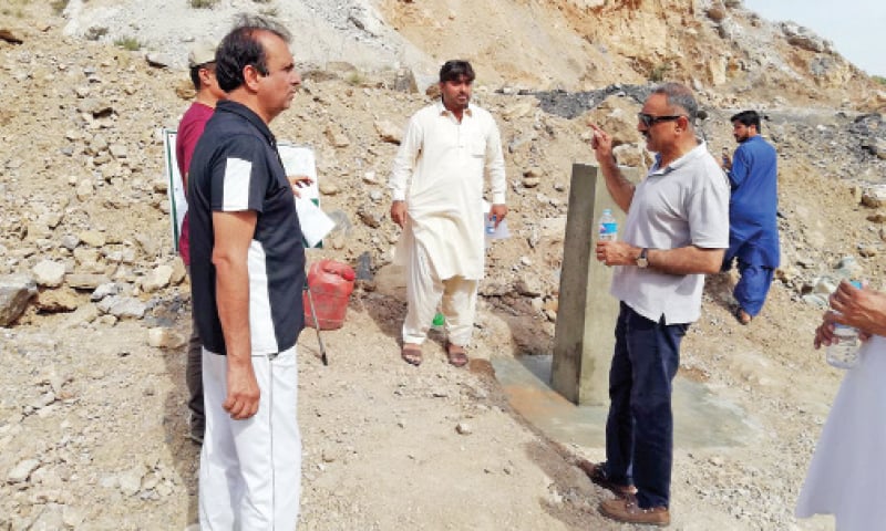 CDA team hold a discussion after fixing a pillar west of Nicholson Monument near Rawalpindi-Peshawar section of G.T. Road and Margalla Pass to demarcate the federal capital&rsquo;s boundary. &mdash; Photo by the writer