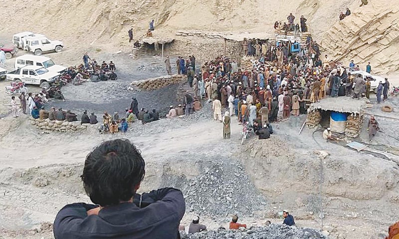 Rescue workers and others gather after a coal mine collapsed in the Marwar area on Saturday.—INP