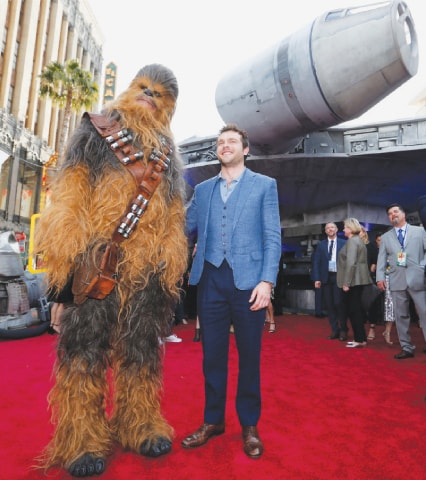 Los Angeles: Cast member Alden Ehrenreich poses with the character of Chewbacca at the premiere for the movie Solo: A Star Wars Story on Thursday.&mdash;Reuters