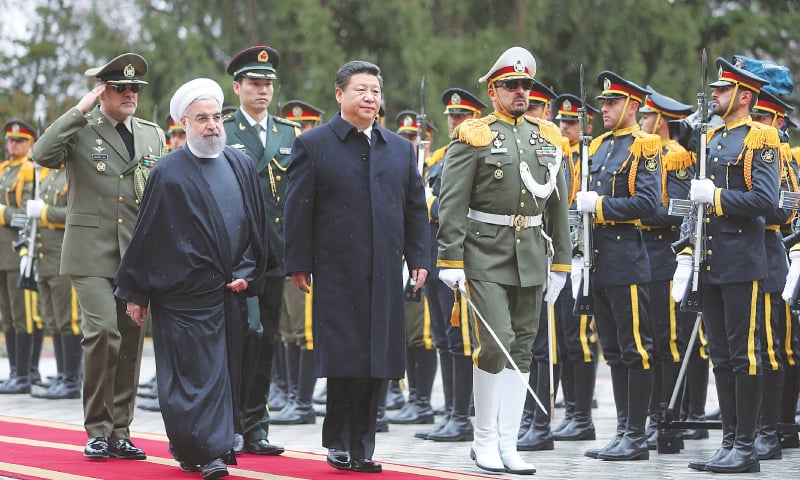 Chinese President Xi Jinping reviews an honour guard as he is welcomed by his Iranian counterpart Hassan Rouhani | File photo