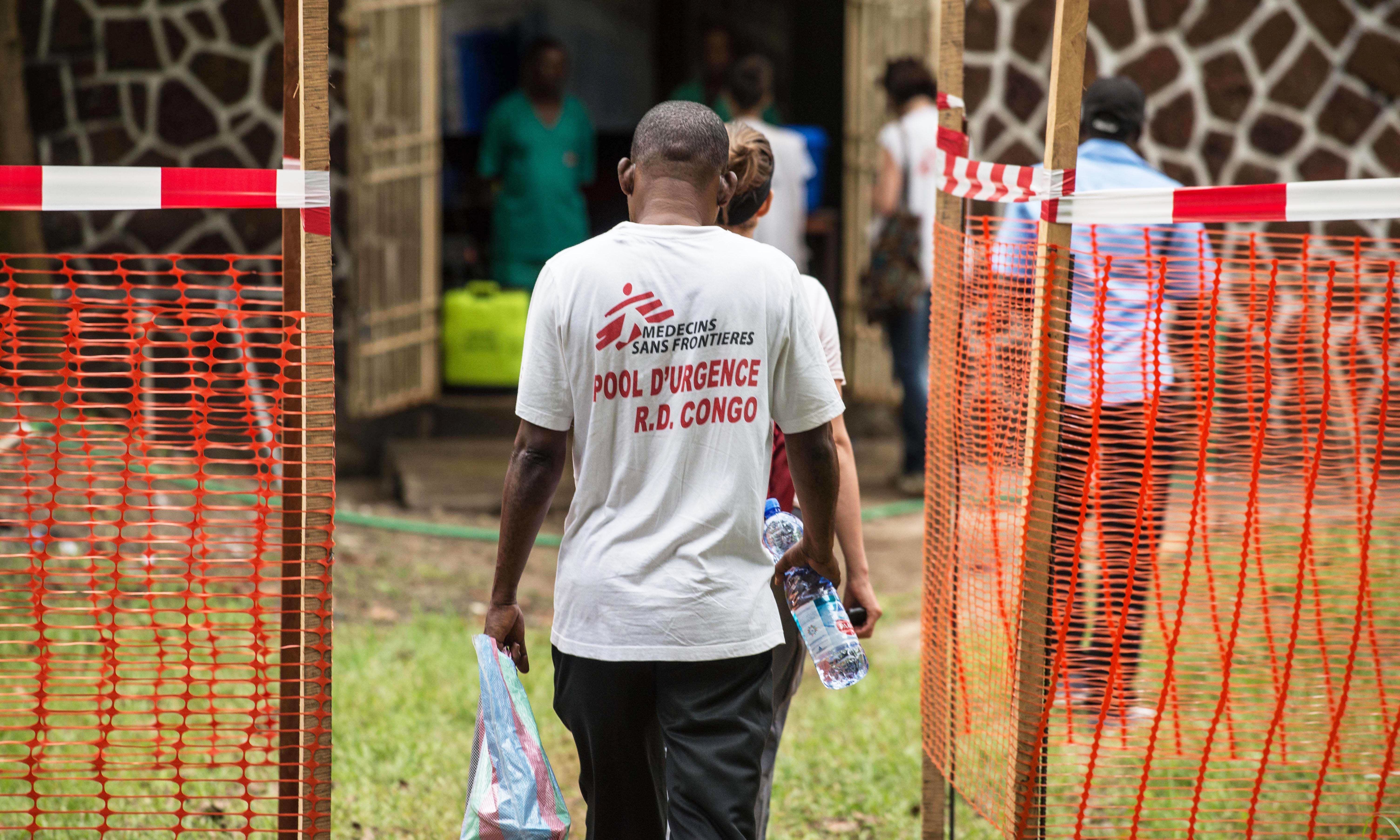 Doctors Without Borders team members walk through an Ebola security zone at the entrance of the Wangata Reference Hospital in Mbandaka, northwest of DR Congo on May 20, 2018. &mdash; AFP